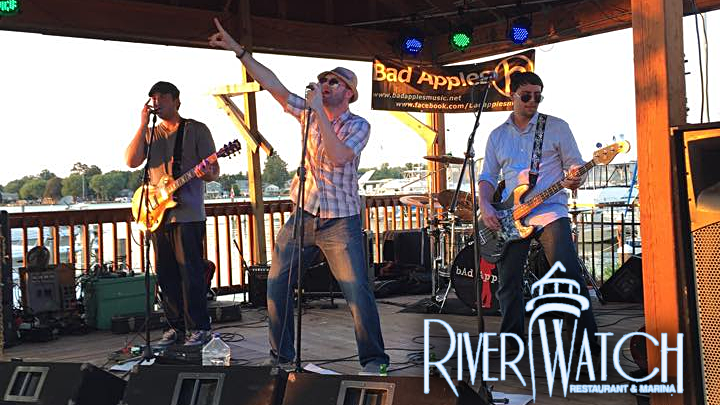 Bad Apples band members rocking on Riverwatch stage